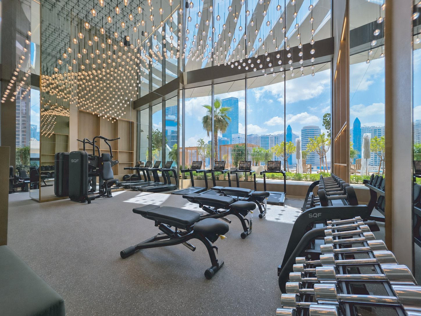 Hotel fitness center with SQF treadmills, adjustable benches, multi-station and dumbbell rack